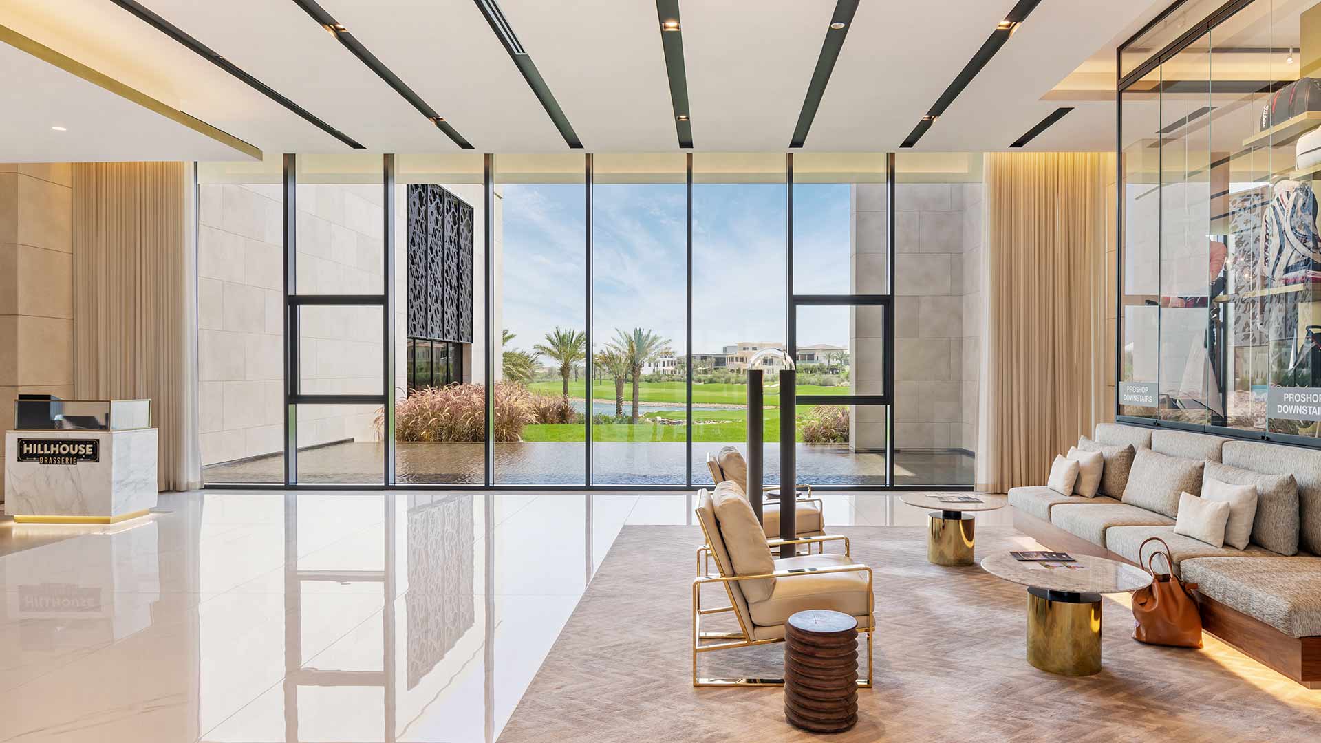 Architectural Lighting Design Modern Sleek Reception Space Seating Glass Display Cabinets Integrated Light Dubai Hills Golf Club Nulty