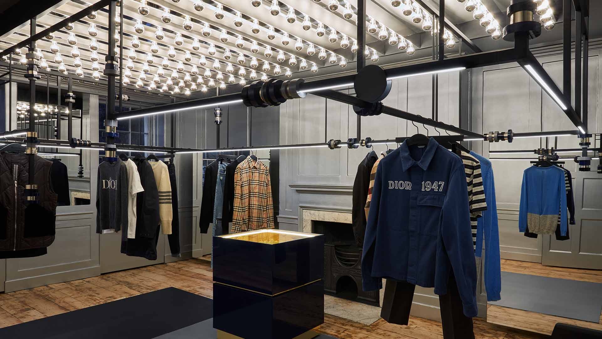 Lighting Scheme Luxury Flagship Boutique Menswear Silver Dipped Bulbs Installation Integrated Illumination Framework Hanging Rails Consultants Nulty
